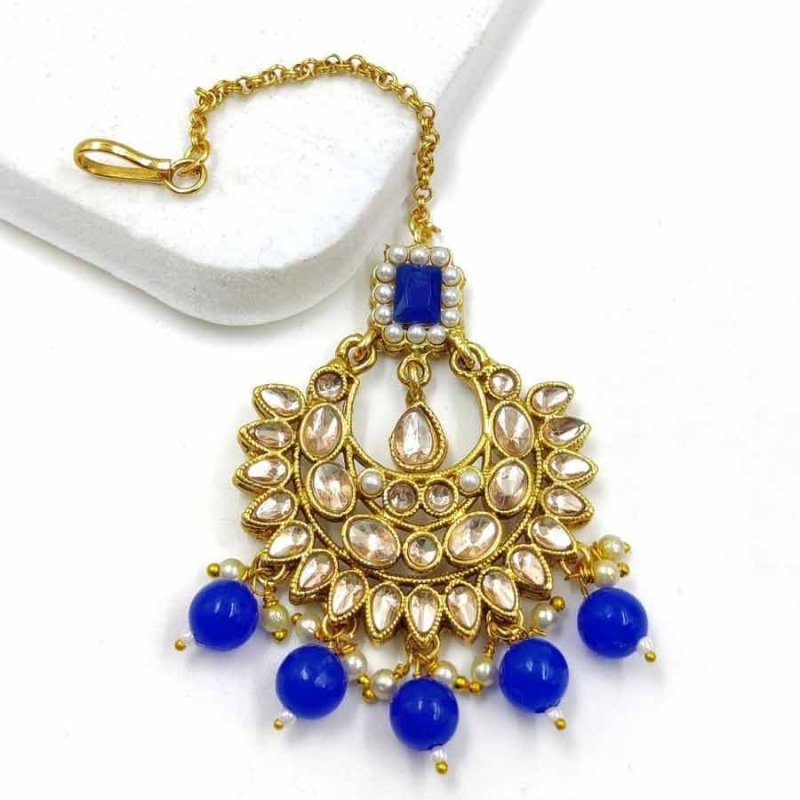 Blue colour wonderful classy traditional mang tikka form kayaa fashion for stylish women like you. It is wonderfully styled with stone and made form metal. This classy mang tikka has pearls beads droplets for stylish look. Buy now!